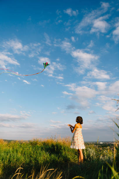 istock Girl playing with kite in field 840827278