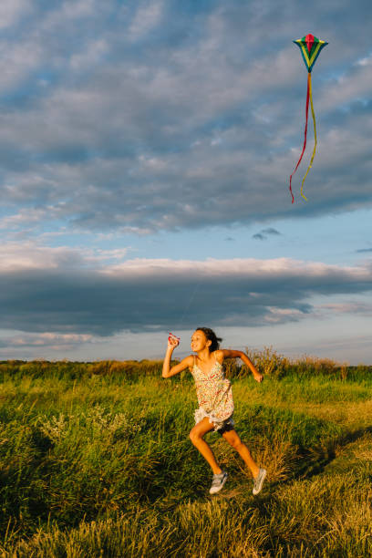 istock Cheerful girl running with kite 840827732