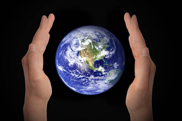 istock Glowing earth globe in hands on black background, environment concept - elements of this image furnished by NASA 840827980