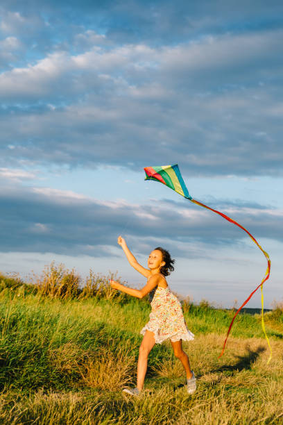 istock Cheerful girl running with kite 840830130