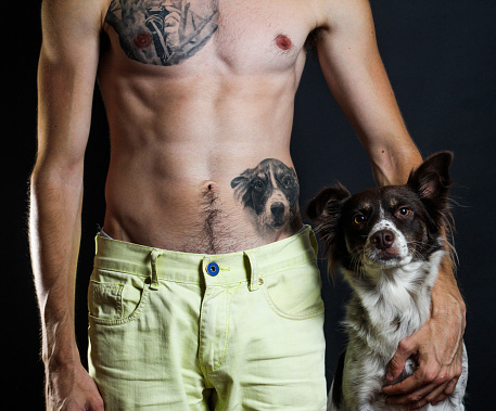 Man, tattoo of his dog, and his dog