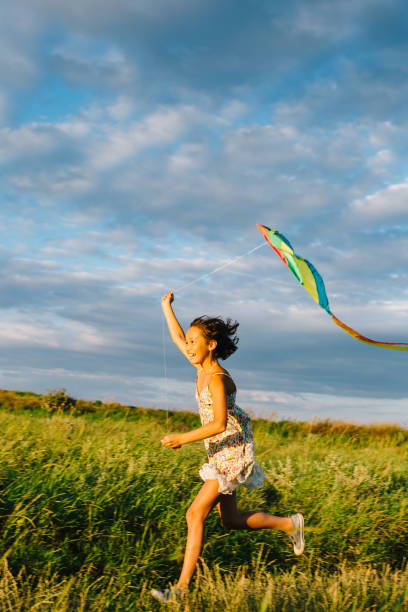 istock Cheerful girl running with kite 840830242