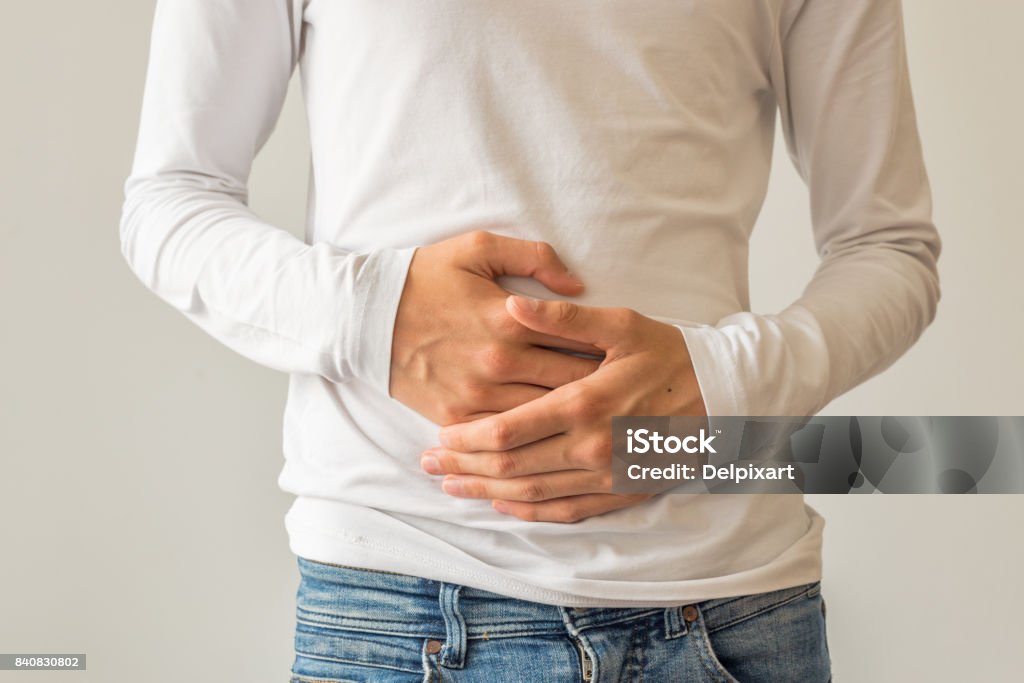 Young man suffering from stomach ache, diarrhea, constipation, acid reflux, indigestion, nausea Abdomen Stock Photo