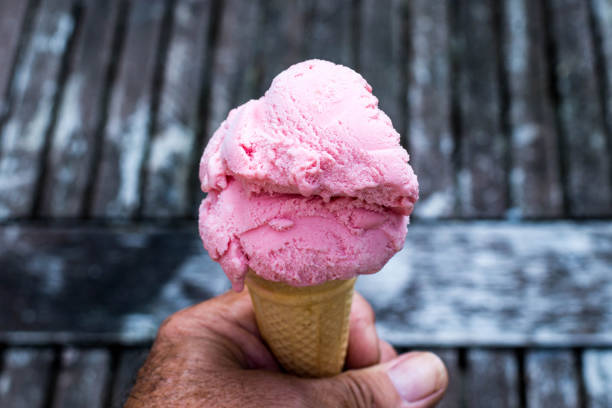 istock Holding a Strawberry Ice Cream Cone 840834744