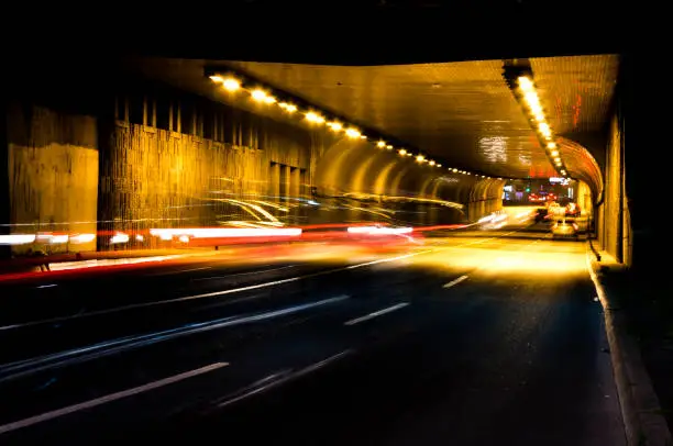 Photo of Night traffic on city street tunnel
