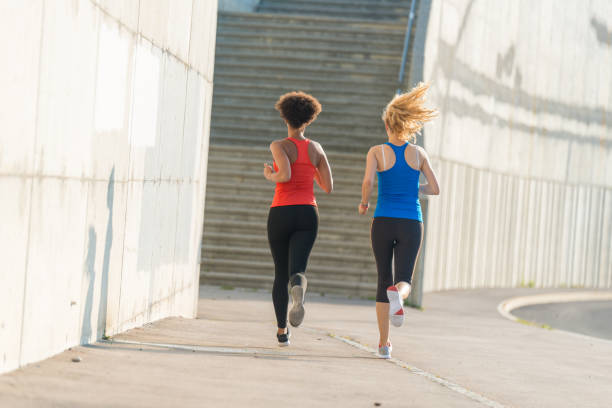 istock Two female athletes running together 840838488