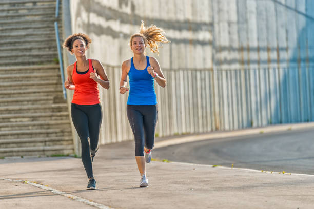 istock Two female athletes running together 840838744