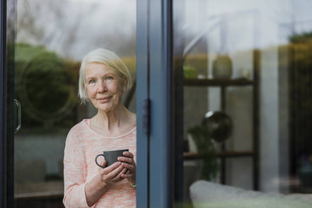 istock Senior Woman At Window 840846084