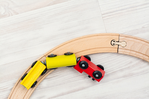 Colorful wooden toy train on laminated floor. Copy space