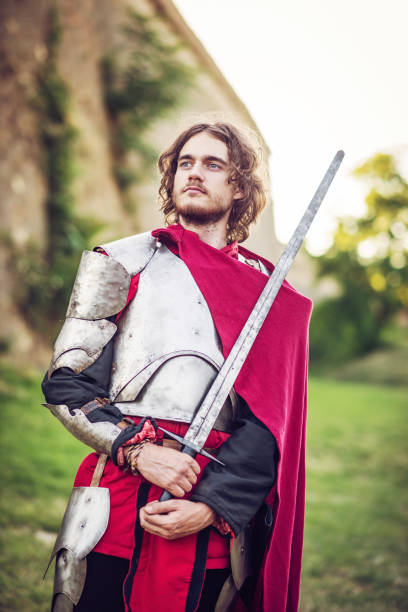 istock Portrait of warrior with sword near stone wall with shield 840846534