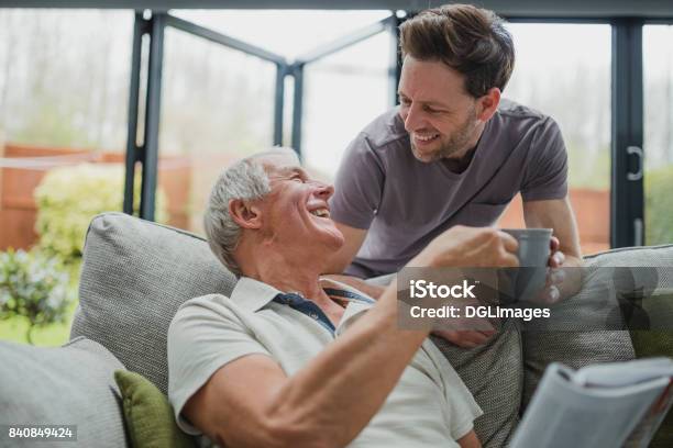 Giving Dad A Well Deserved Cuppa Stock Photo - Download Image Now - Care, Family, Father