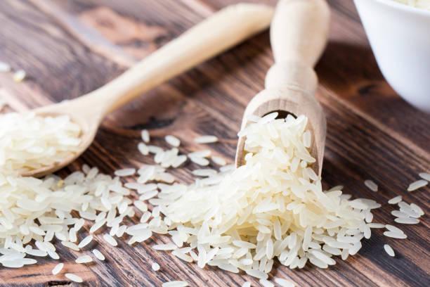 istock Rice spoon plate Wooden table background 840849704