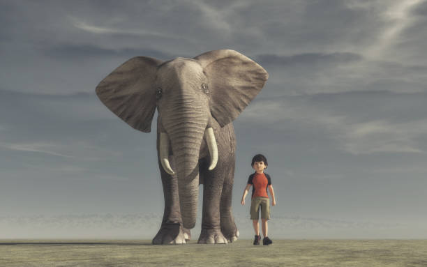 istock The boy goes and a big elephant 840855472