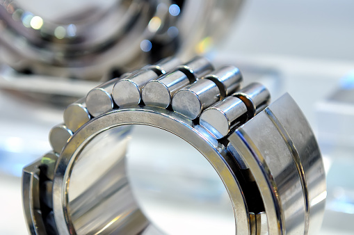 Industrial roller bearing on a light background. Shallow depth of field, selective focus