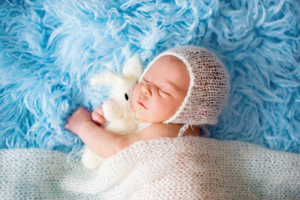 istock Little cute newborn baby boy, sleeping wrapped in white wrap 840858590