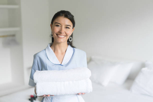 istock Housekeeper working at a hotel and holding clean towels 840862564