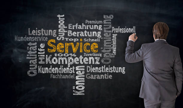 istock Businessman writes service (in german Competence, consulting) cloud on blackboard concept 840863456