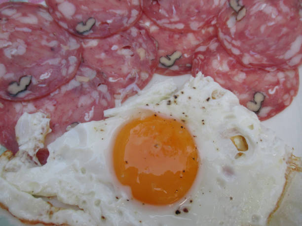 istock Egg on the plate with sausage slices with walnuts 840869700