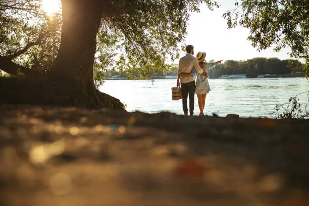 Rear view of a couple enjoying the view on the river.