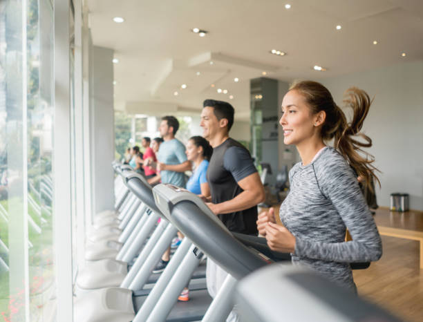 istock People at the gym running on the treadmills 840874700