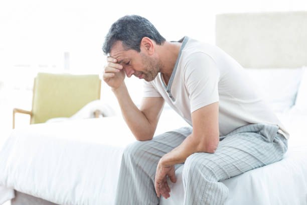istock Worried man sitting on bed 840881676