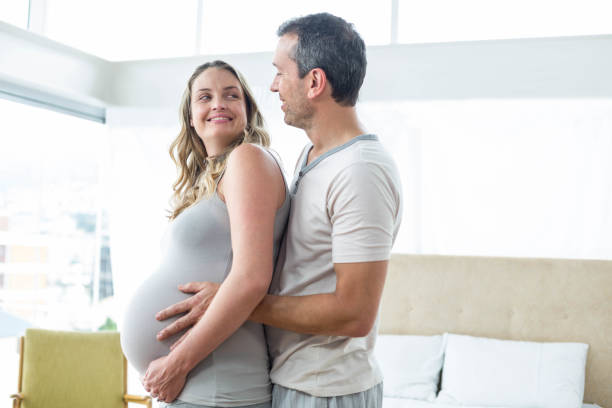 istock Man holding pregnant womans stomach 840881878