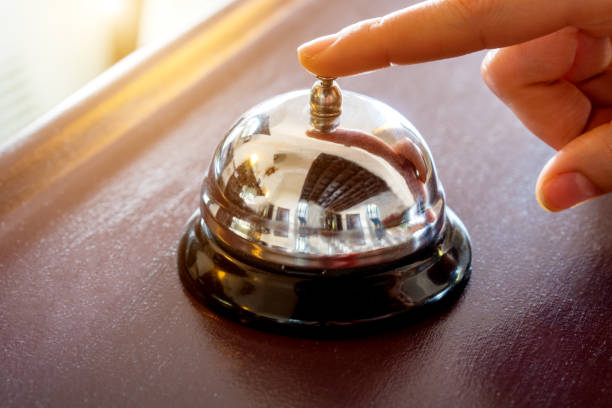 female hand presses the button female hand presses the button of a bell in a hotel bellhop photos stock pictures, royalty-free photos & images
