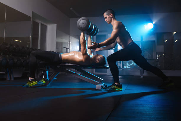 istock two men twin brothers training with dumbbells, exercising working out at the gym 840883952