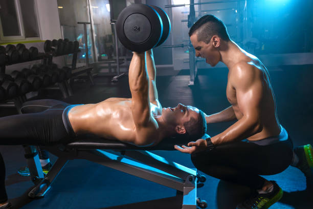 istock two men twin brothers training with dumbbells, exercising working out in gym 840884162