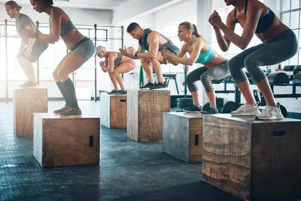 Shot of a fitness group box jumping at the gym