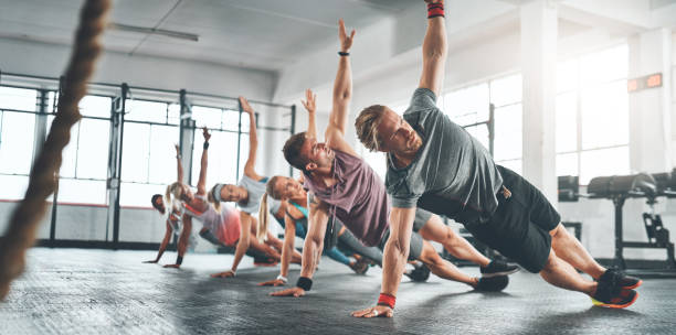 Fitness is something you attain and maintain Shot of a fitness group working out at the gym exercise class photos stock pictures, royalty-free photos & images