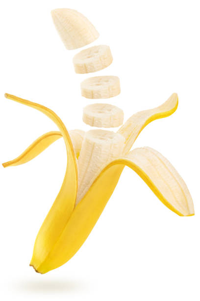 sliced banana floating on white background stock photo