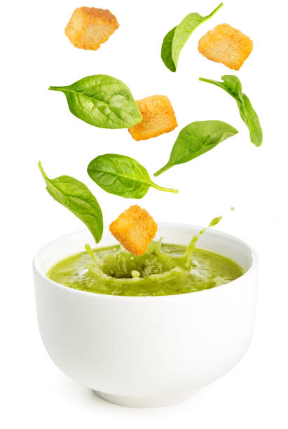 istock spinach and croutons falling into a soup bowl 840887902