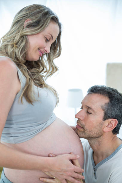 istock Man holding pregnant womans stomach 840891166