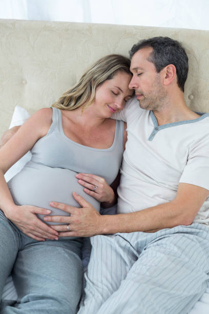 istock Expecting couple sitting on bed 840891614