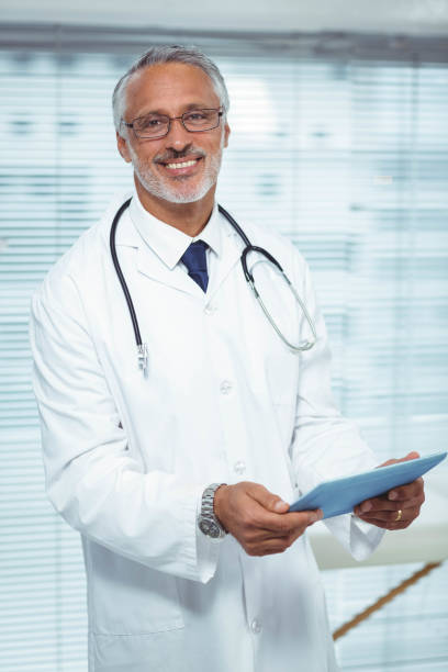 istock Happy doctor holding clipboard 840891970