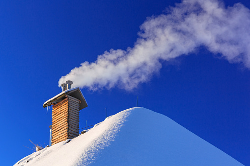 Tall industrial chimney with blue sky.