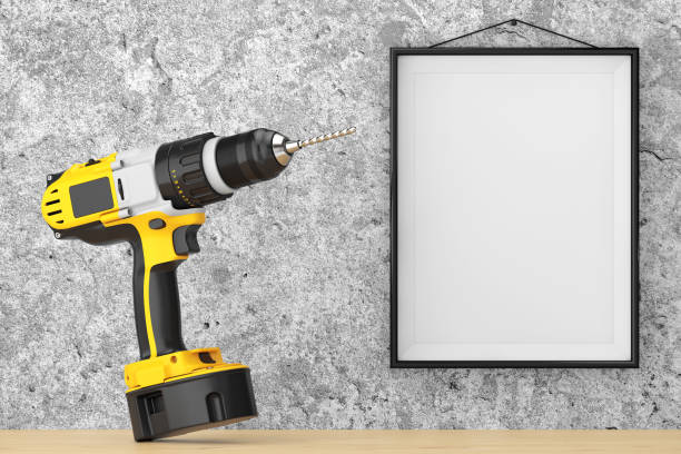 istock Yellow Rechargeable and Cordless Drill in front of Concrete Wall with Blank Frame. 3d Rendering 840905062