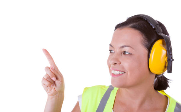 istock Attractive Woman Worker in Safety Jacket and Protective Ear Headphones with Copyspace for Yours Design 840907906