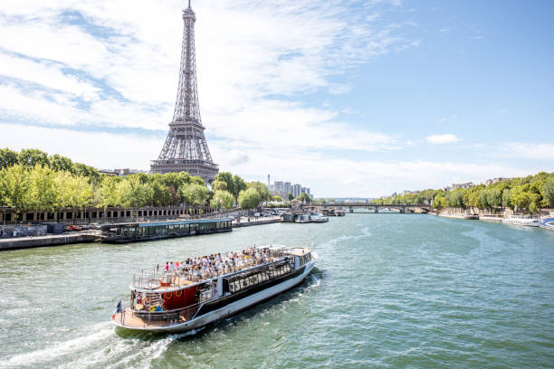 Landscape view of Paris Landscpae view on the Eiffel tower and Seine river with tourist boat in Paris passenger craft stock pictures, royalty-free photos & images