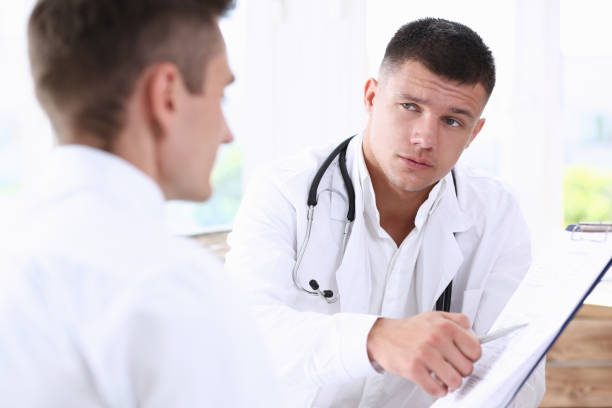 istock Concerned handsome doctor communicate with patient 840915306