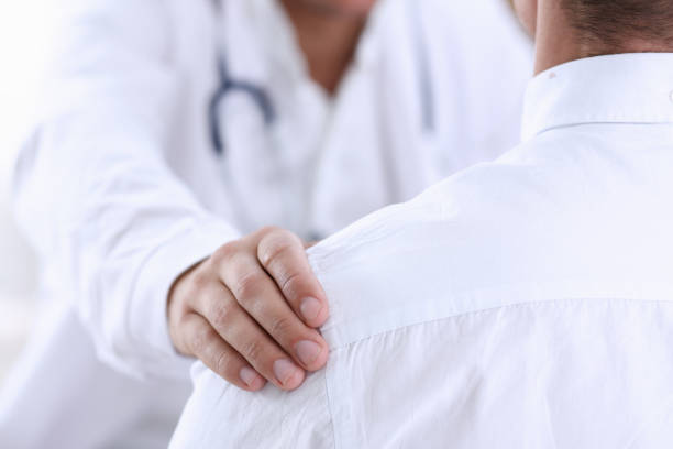 istock Friendly male doctor hold patient shoulder in office during reception 840915374