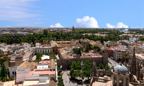 The Alcázar of Seville The Alcázar of Seville can be seen in the middle background. It is regarded as one of the most outstanding examples of mudéjar architecture found on the Iberian Peninsula, Spain el alcazar palace seville stock pictures, royalty-free photos & images