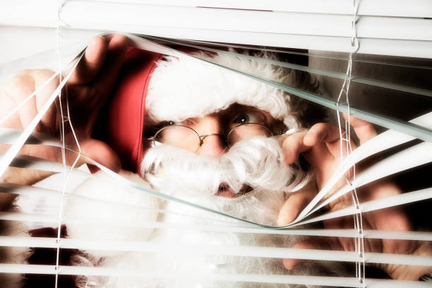 istock Santa Claus peeks through the blinds on a window 840918204