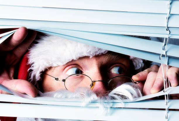 istock Santa Claus peeks through the blinds on a window 840920110