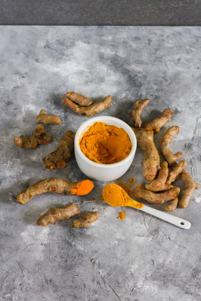 istock Turmeric root and ground turmeric. White bowl, gray background. 840920764
