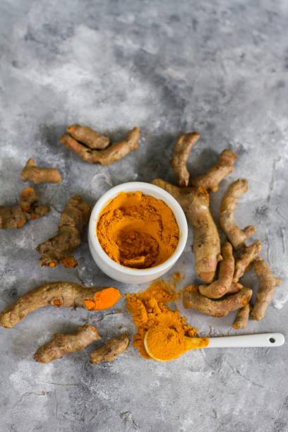 istock Turmeric root and ground turmeric. White bowl, gray background. 840921094