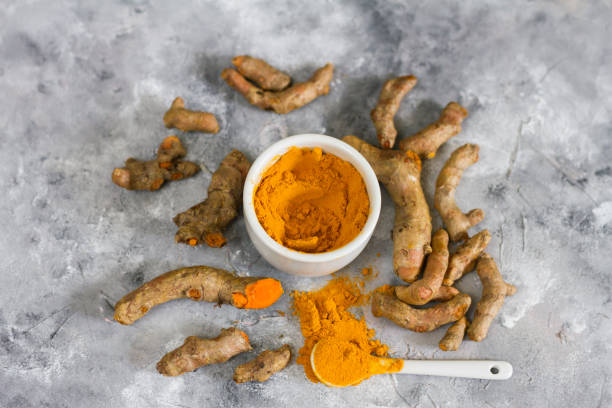 istock Turmeric root and ground turmeric. White bowl, gray background. 840921096