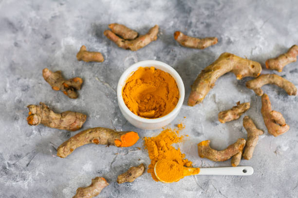 istock Turmeric root and ground turmeric. White bowl, gray background. 840922842