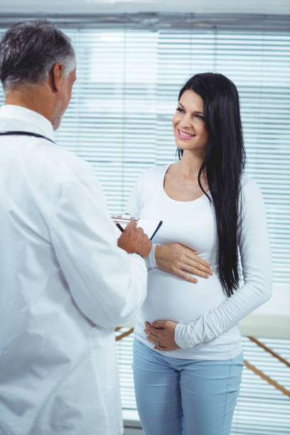 istock Pregnant woman interacting with doctor 840923290